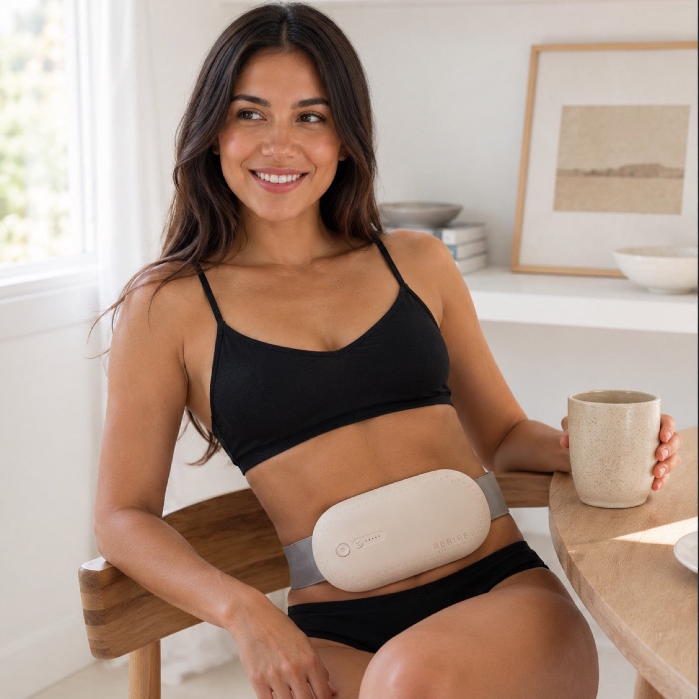 A woman making coffee in her kitchen, the NuFemme belt worn under her top