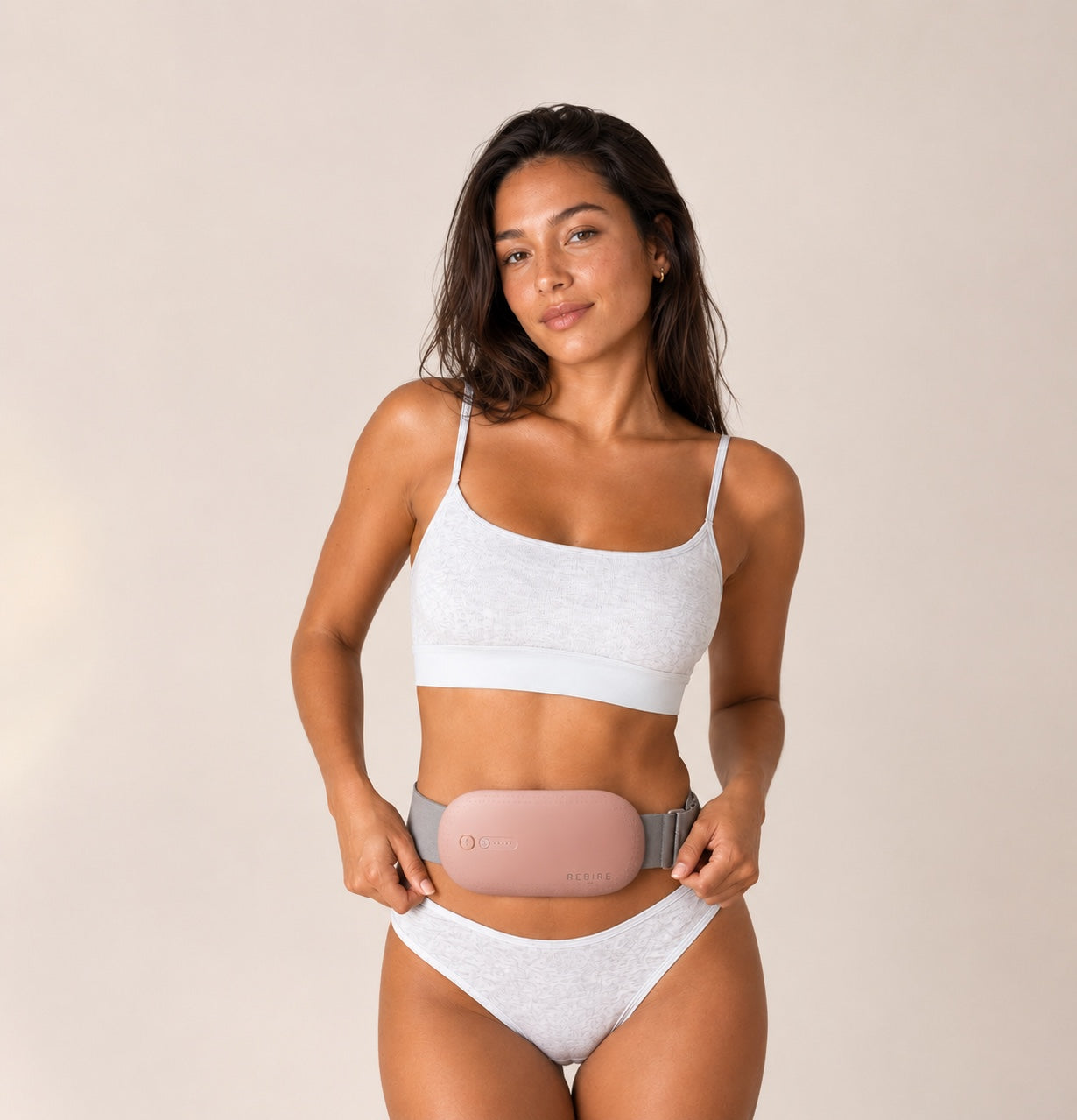 A woman wearing the Rebire belt at her lower abdomen